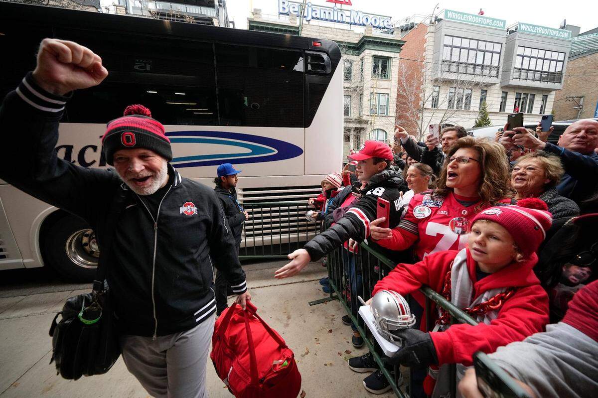 Ohio State Buckeyes defensive coordinator Jim Knowles waves to fans as the team buses arrive prior to the NCAA football game between the Ohio State Buckeyes and the Northwestern Wildcats at Wrigley Field in Chicago on Saturday, Nov. 16, 2024.