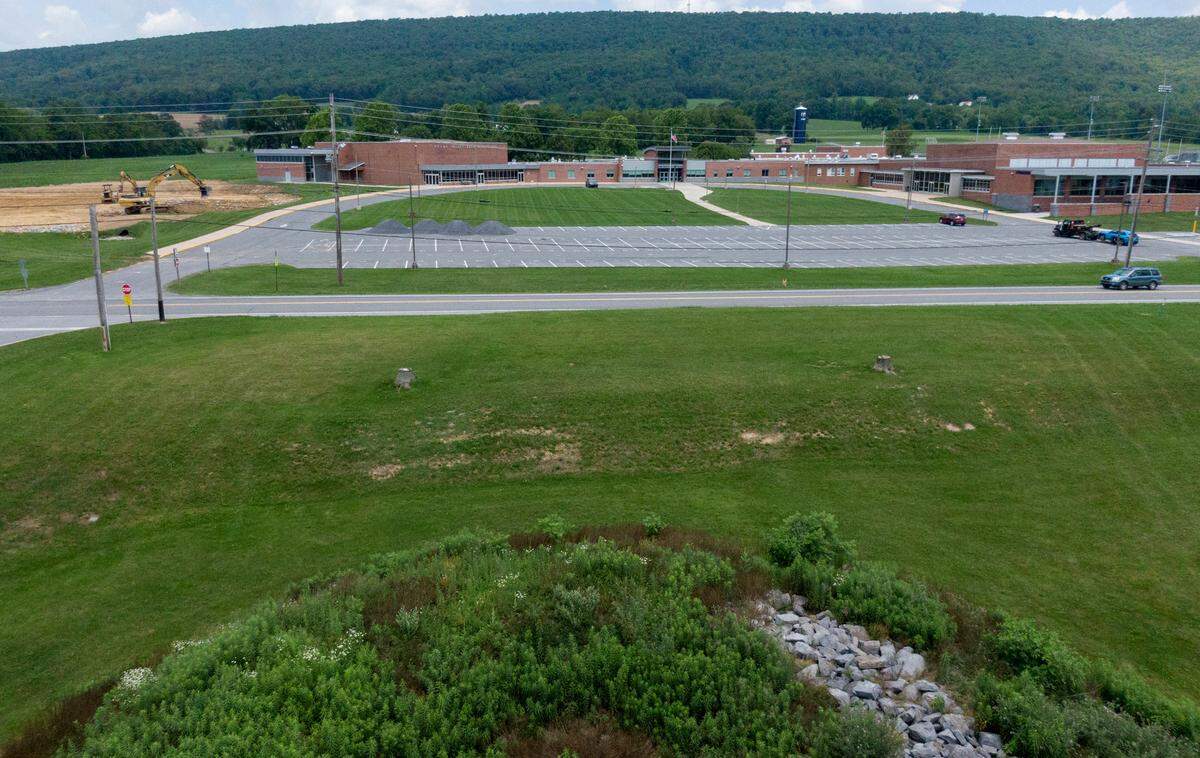 A new pedestrian crosswalk with safety lights will be installed to cross Route 45 between the Penns Valley Area High School and the Penns Valley Elementary & Intermediate School. Traffic moves along Route 45 as work on the new parking area is underway on Thursday, July 6, 2023.
