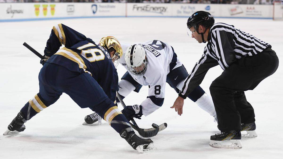 Penn State forward Chase Berger faces off against Notre Dame forward Jake Evans during a game last season. The Nittany Lions and Fighting Irish will square off in South Bend, Ind., on Friday and Saturday.