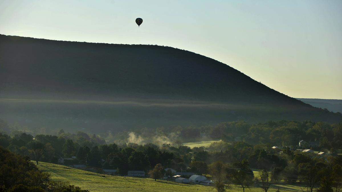 A balloon flies over Mount Nittany in the early morning October 6, 2011 in State College, Pa.