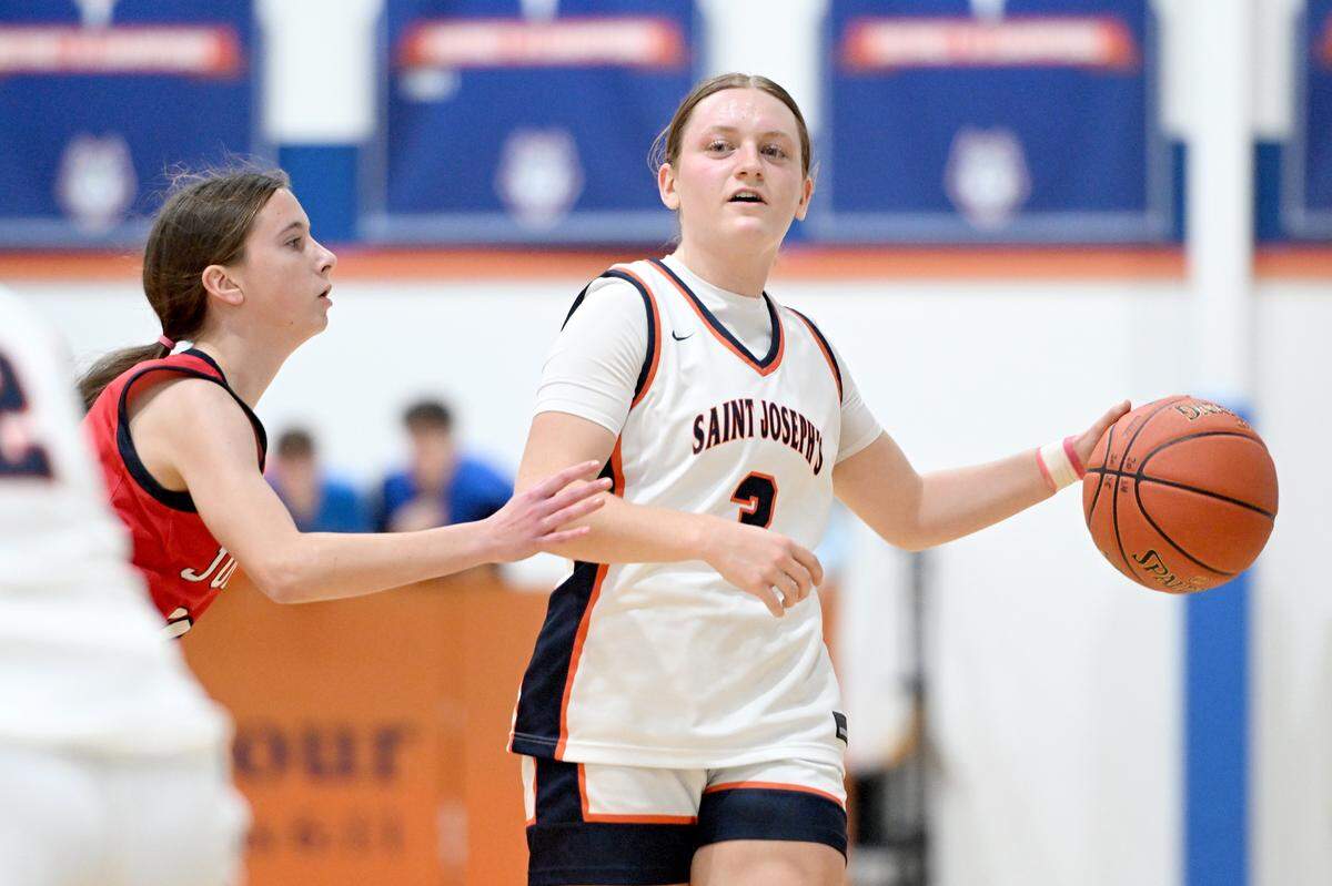 Saint Joseph’s Catholic Academy’s Naomi Crispin dribbles around a Juniata defender during the game on Thursday, Jan. 23, 2025. Saint Joseph’s Catholic Academy won, 72-34.