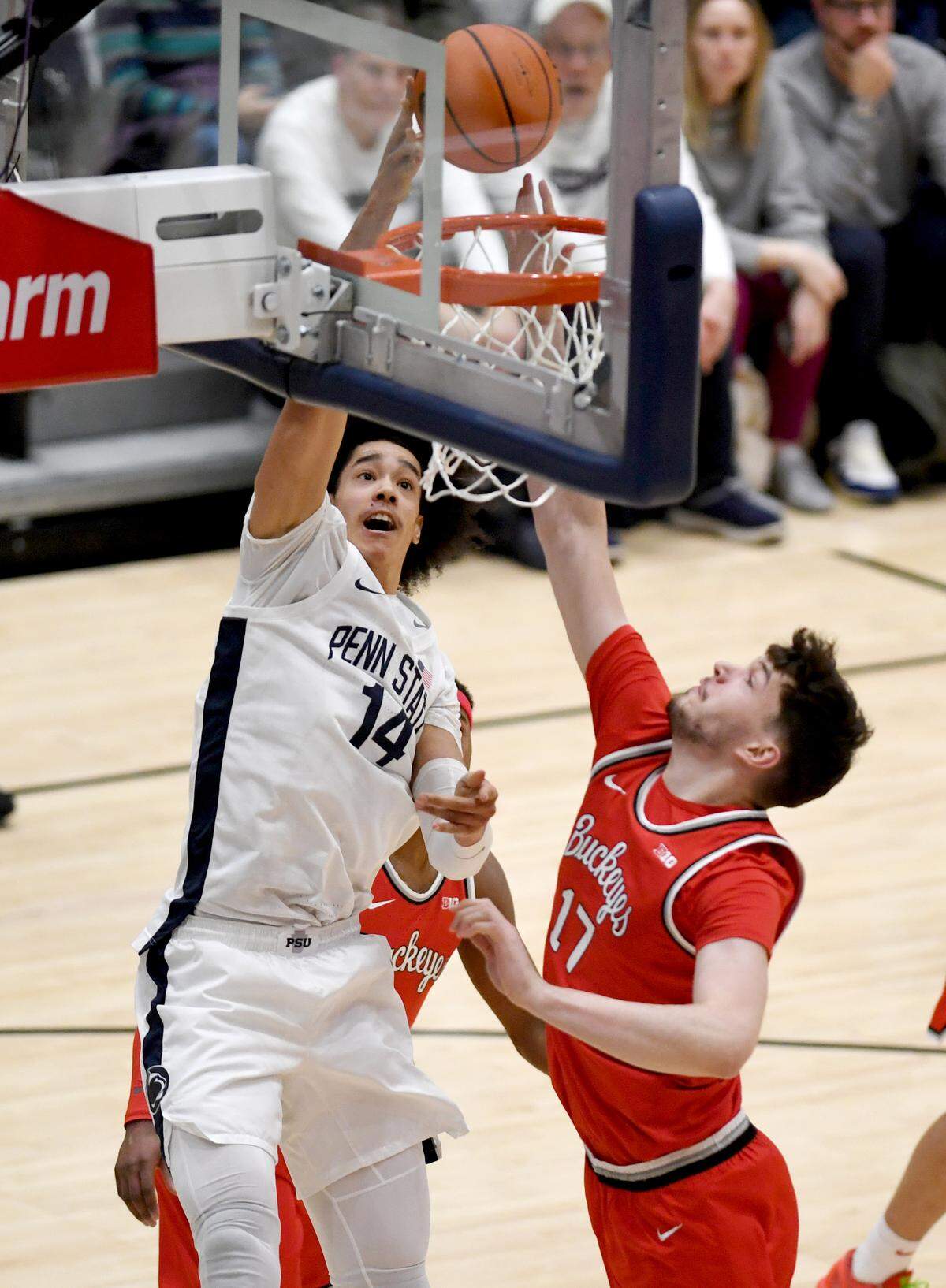 Penn State’s Yanic Konan Niederhauser goes in for a basket around Ohio State’s Ivan Njegovan during the game on Thursday, Jan. 30, 2025 at Rec Hall.