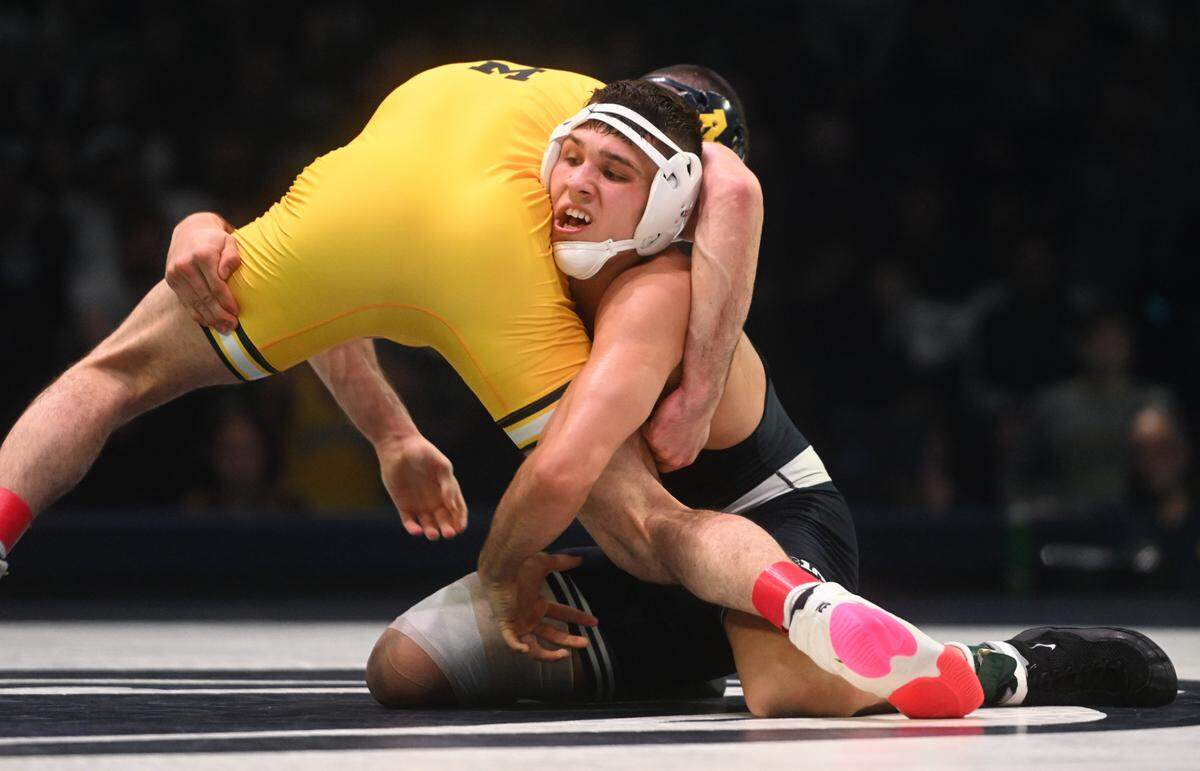Penn State’s Alex Facundo wrestles Michigan’s Cameron Amine in the 165 lb bout of the match on Friday, Jan. 20, 2023 at the Bryce Jordan Center.