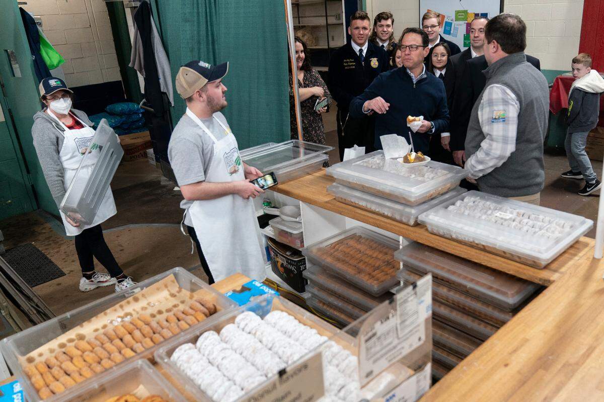 Gov.-elect Josh Shapiro, second top right, tours the Pennsylvania Farm Show in Harrisburg on Jan. 11.