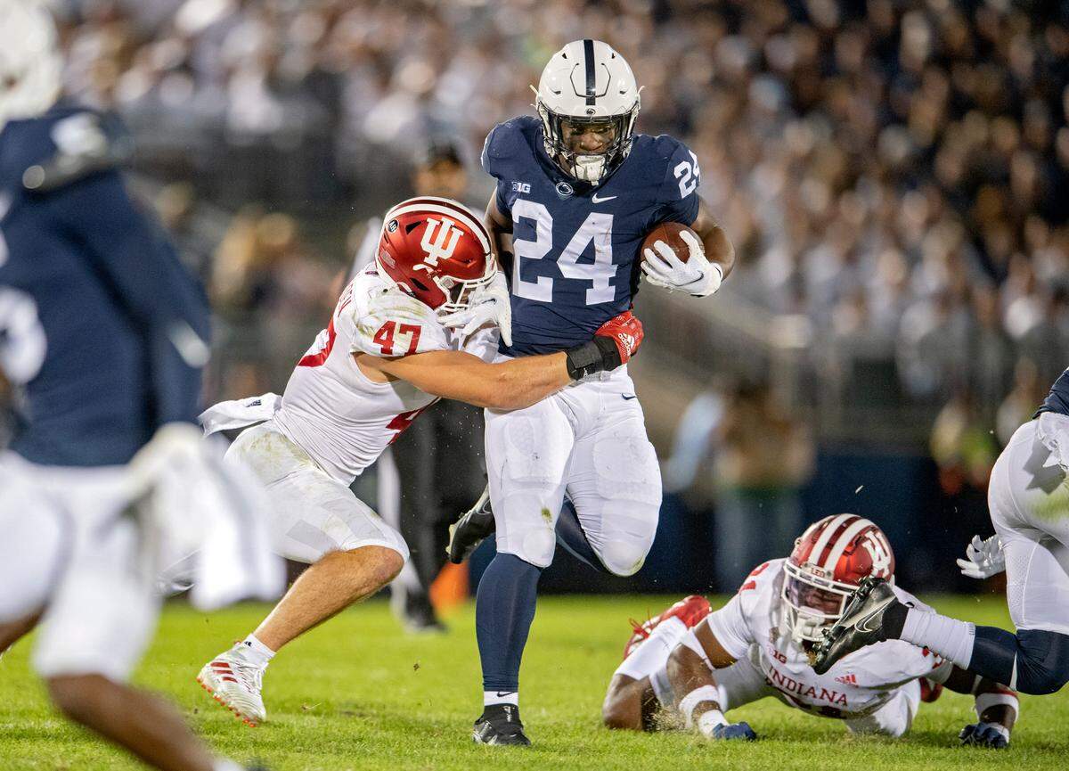 Penn State running back Keyvone Lee cuts down the field with the ball past Indiana’s Micah McFadden.