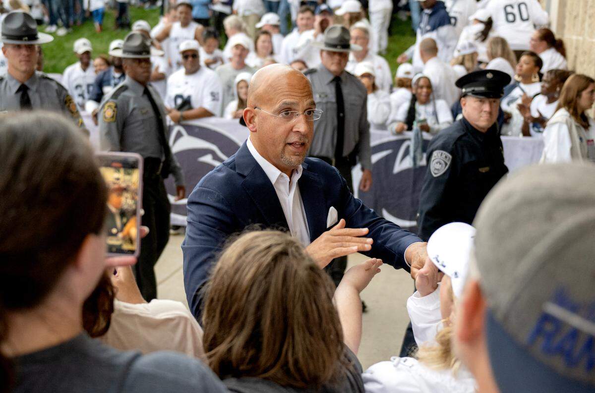 Penn State football coach James Franklin greets fans as he and the team arrive at Beaver Stadium for the Homecoming game on Saturday, Sept. 28, 2024.