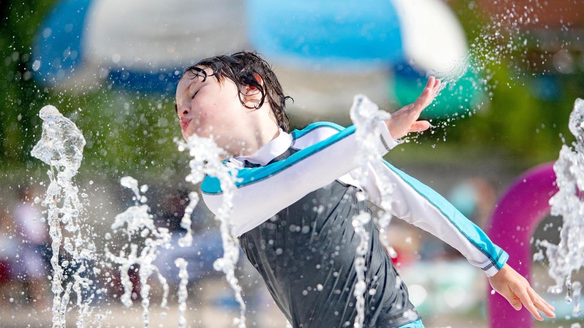 Cooper Bonsall, 6, splashes through the fountains at the Welch Pool with his friend in this 2020 file photo. This summer may be hotter than usual in State College, according to a forecast from the National Weather Service.