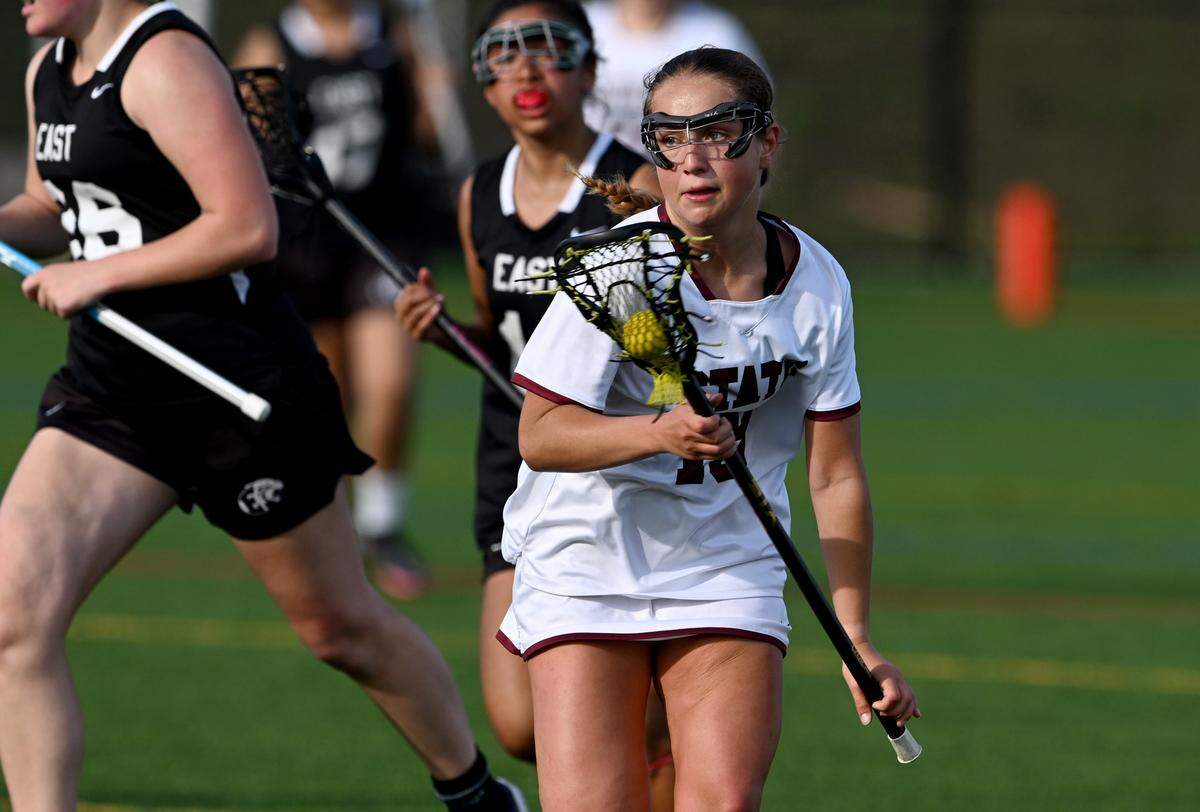 State College’s Caitlyn Keiter cuts around CD East defenders during the game on Thursday, April 20, 2023.
