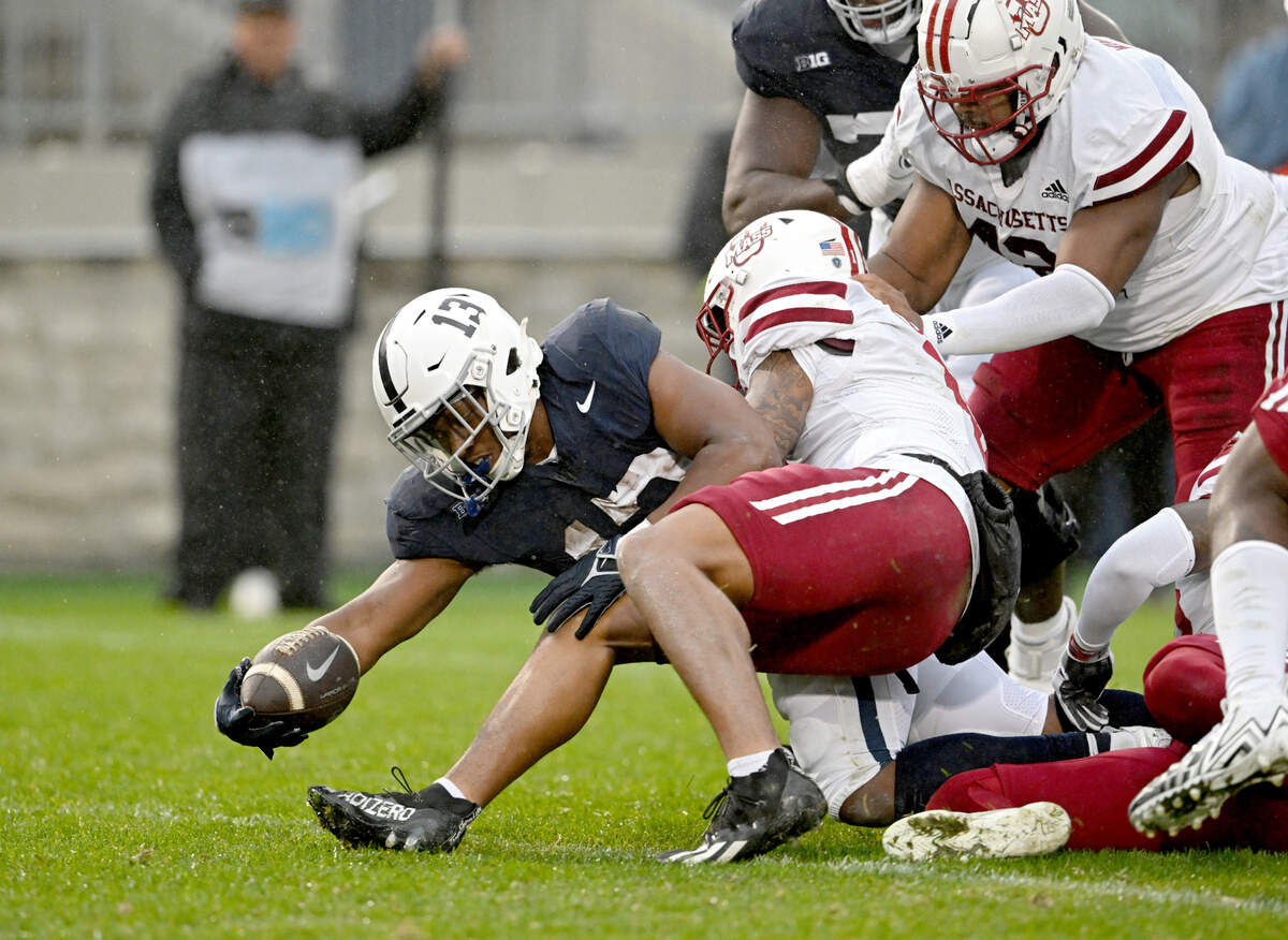 UMass defenders can’t stop Penn State running back Kaytron Allen as he reaches into the end zone for a touchdown during the game on Saturday, Oct. 14, 2023.  