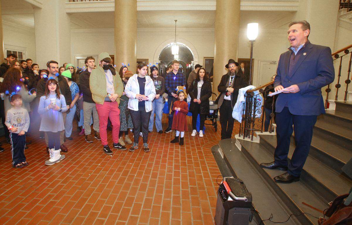 State Rep. Paul Takac addresses the crowd Sunday before the lighting of a 6 foot tall public Jewish Hanukkah menorah on the fourth night of the eight-day Festival of Lights, hosted by Chabad of Penn State, at Old Main.