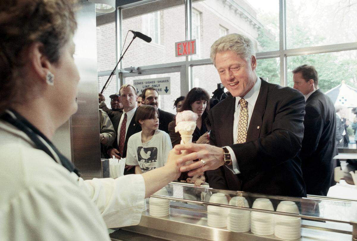President Bill Clinton accepts a cone of Peachy Paterno and Cherry Quist from Kathleen Schuckers, University Creamery group leader, in 1996.