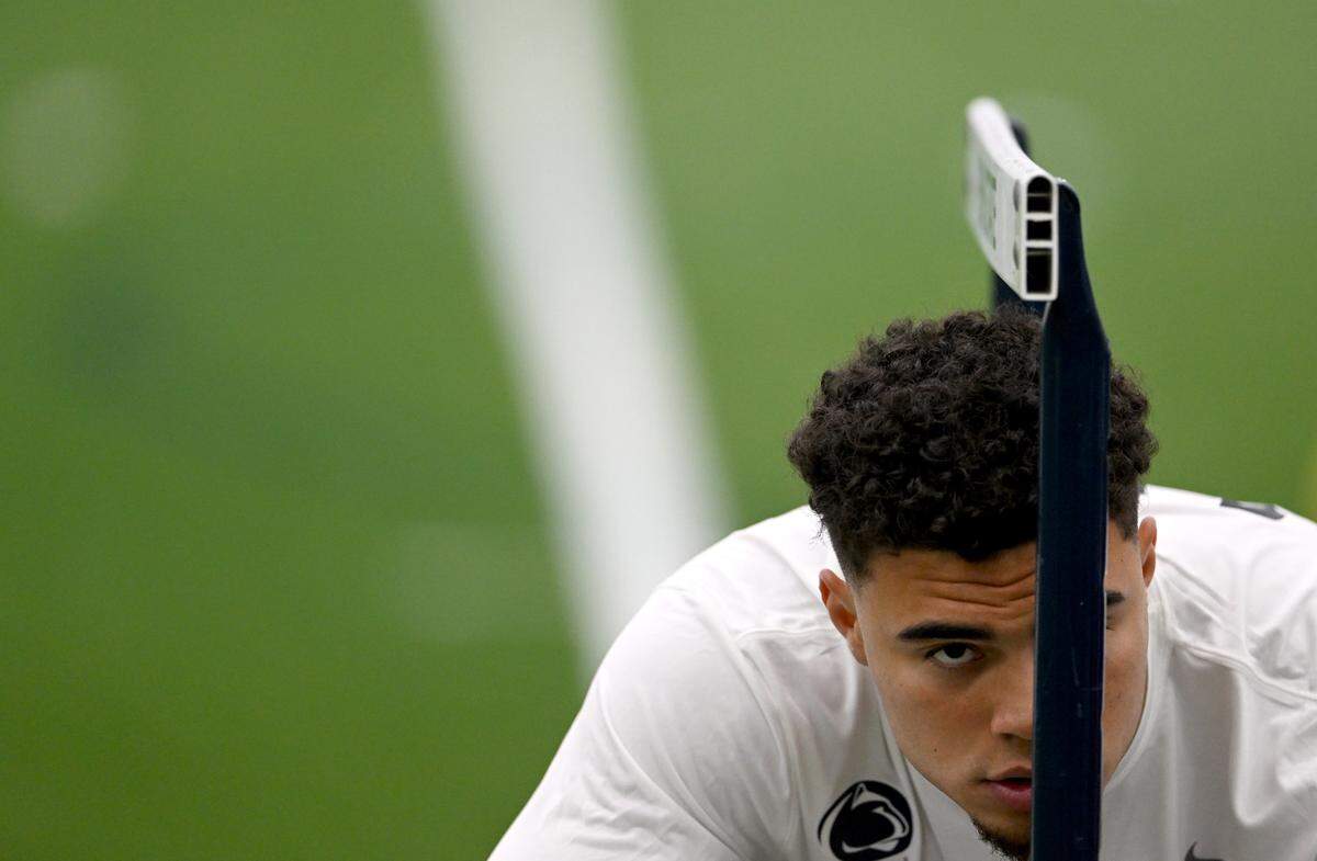 Tight end Brenton Strange stretches under a hurdle during Penn State football’s Pro Day on Friday, March 24, 2023.