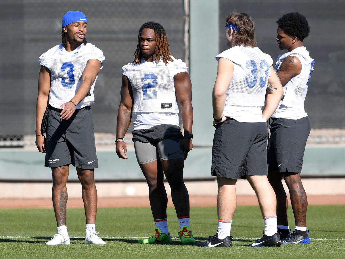 Boise State running back Ashton Jeanty talks with his teammates during practice for the Fiesta Bowl on Sunday, Dec. 29, 2024 Indian School Park.