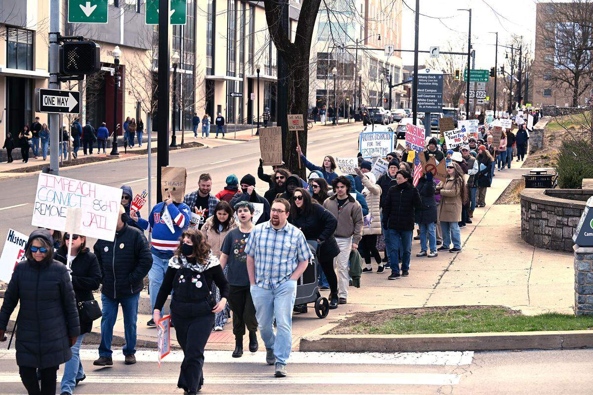 Protesters marched along College Avenue following a rally as part of the No Kings anti-Trump rally on Saturday.