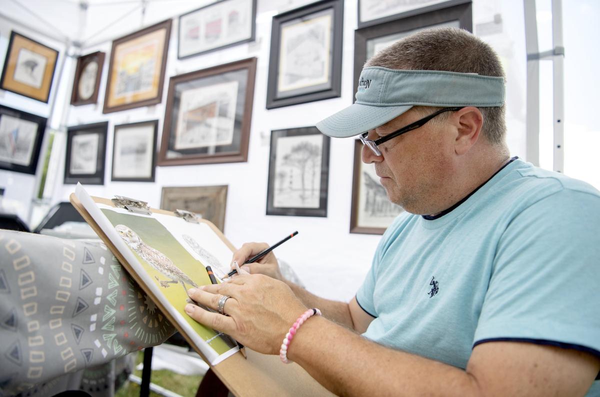 Frank LaMartina works on a piece of an owl in his booth at the People’s Choice Festival of Pennsylvania Arts & Crafts at the Pennsylvania Military Museum in Boalsburg on Friday, July 12, 2019.  LaMartina, from Red Lion, does all graphite and color pencil drawings.