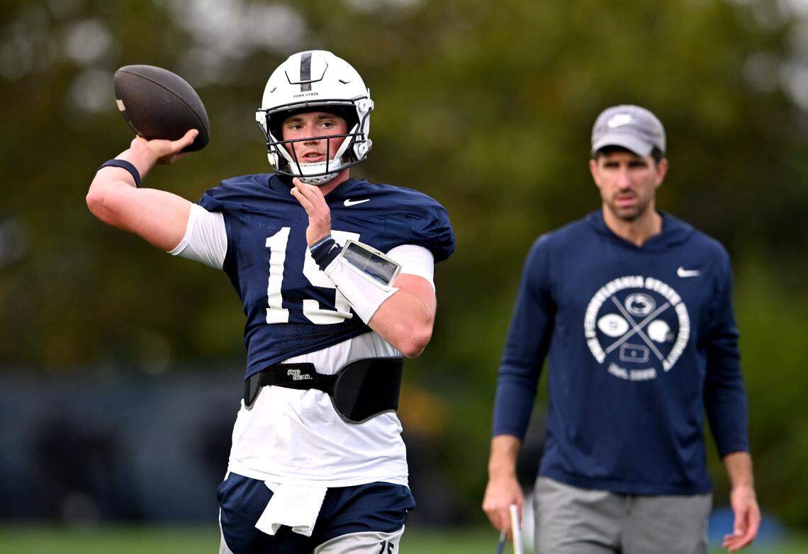 Penn State quarterback Drew Allar makes a pass as quarterbacks coach Danny O'Brien watches during practice on Tuesday, Sept. 16, 2025.