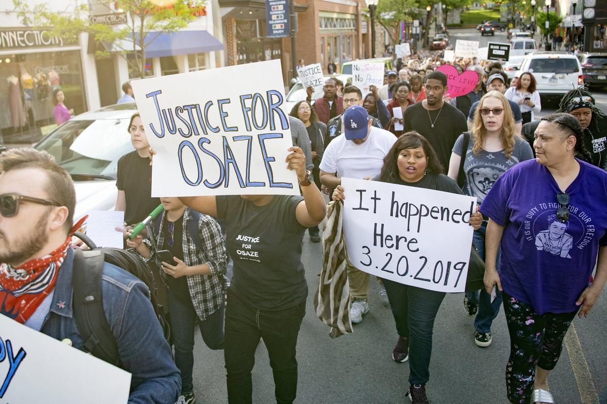 Michelle Kenney, right, the mother of Antwon Rose II, marches with protest organizer Lorraine Jones carrying an “It happened here” sign. A large crowd of community members rallied in downtown State College on Wednesday evening, following the announcement that no charges would be filed in the officer-involved fatal shooting of Osaze Osagie.