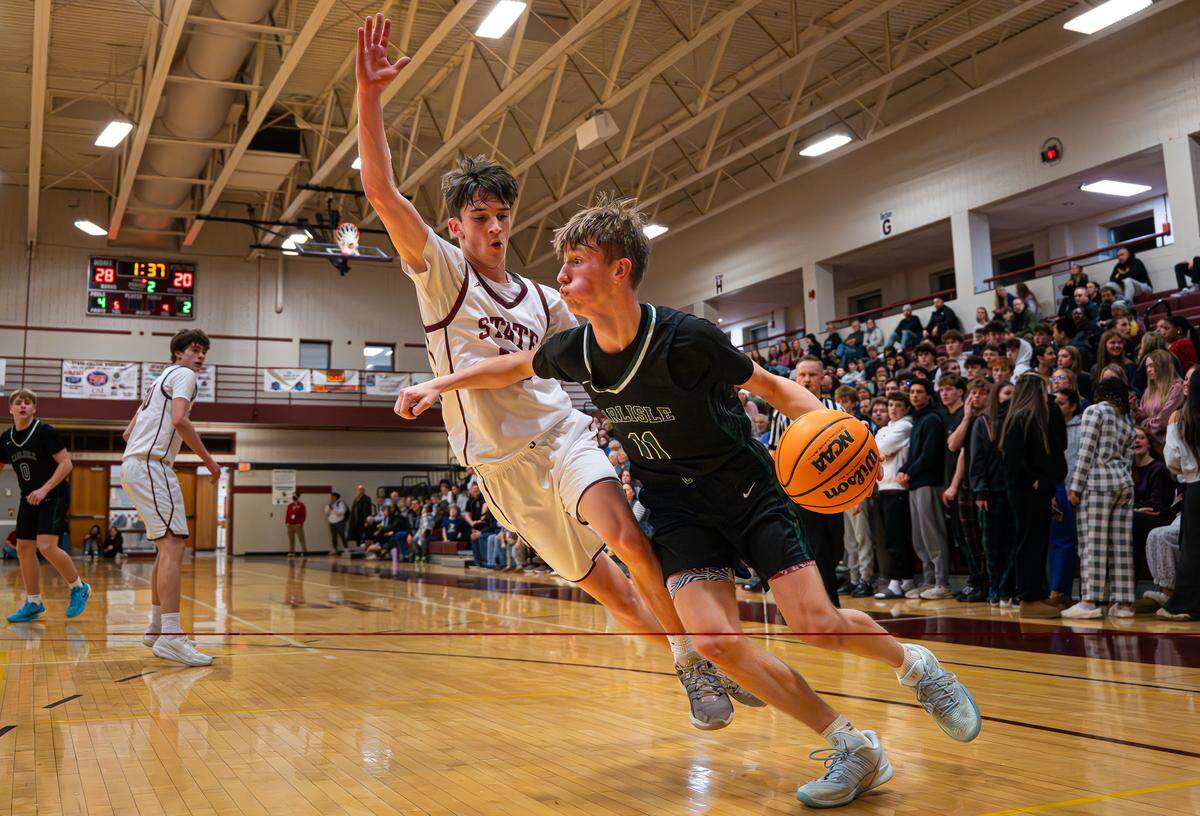 Carlisle’s Masyn McMeekin (11) drives past a State High defender during the boys basketball game at State College Area High School on Friday, Jan. 23, 2026, in State College, Pa. The Thundering Herd lost to the Little Lions 62-53.