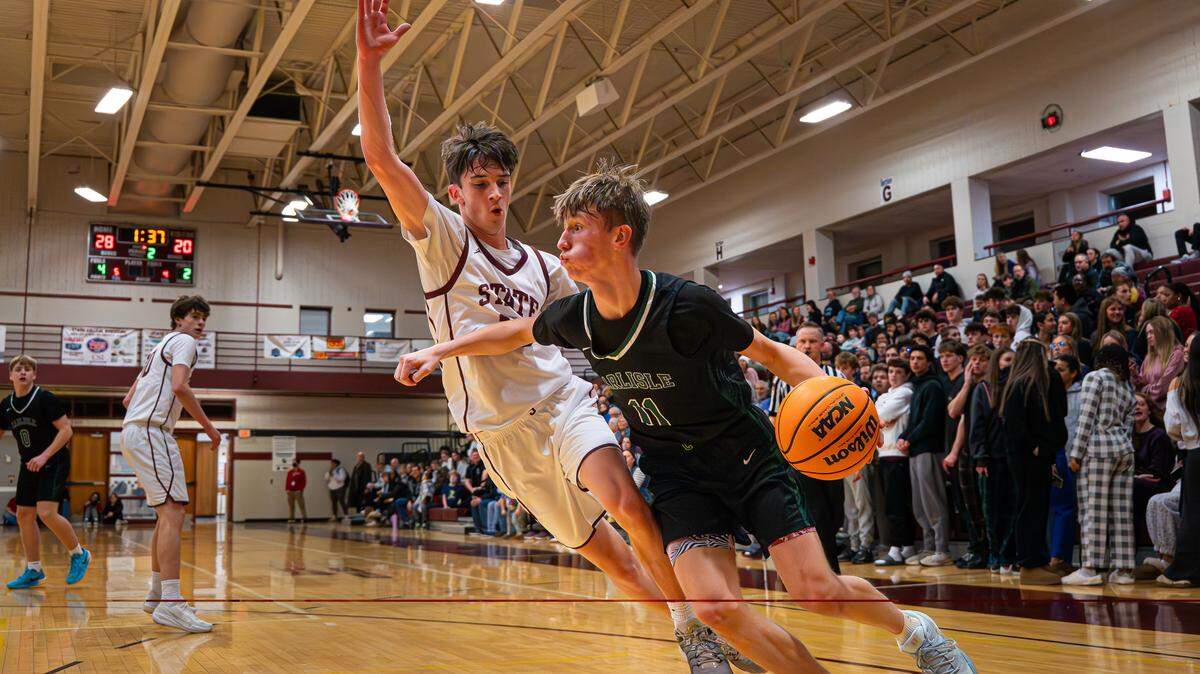 Carlisle’s Masyn McMeekin (11) drives past a State High defender during the boys basketball game at State College Area High School on Friday, Jan. 23, 2026, in State College, Pa. The Thundering Herd lost to the Little Lions 62-53.