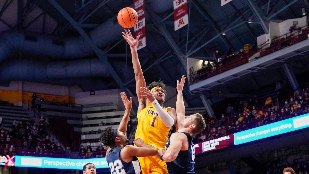 Minnesota forward Eric Curry (1) takes a shot over Penn State guard Jalen Pickett (22) and forward John Harrar during the first half an NCAA college basketball game Saturday Feb. 12, 2022, in Minneapolis. (AP Photo/Craig Lassig)