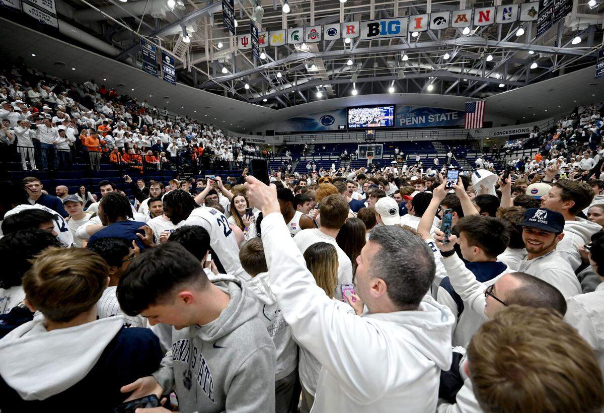 Penn State fans rush the court to celebrate the men’s basketball win over Illinois on Wednesday, Feb. 21, 2024 at Rec Hall.