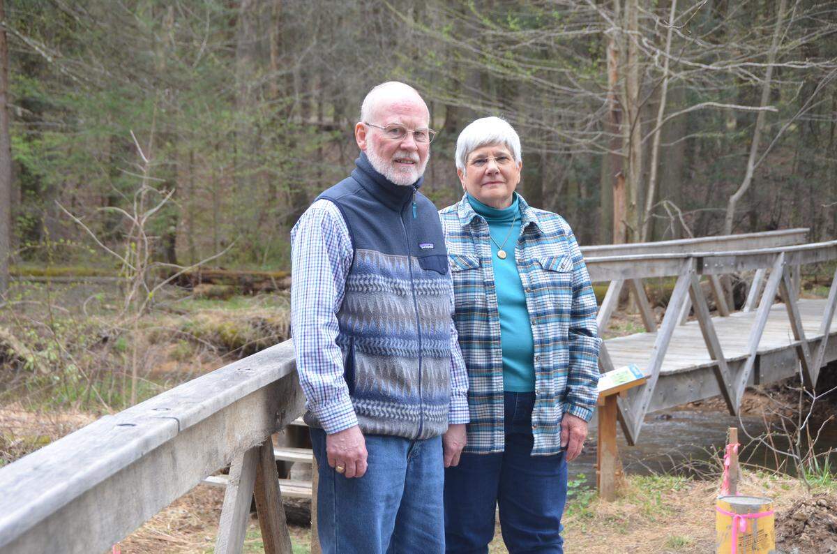 Steve and Joan Turns on the bridge at Shaver’s Creek. The couple donated a $100,000 endowment to the center’s school day programs.