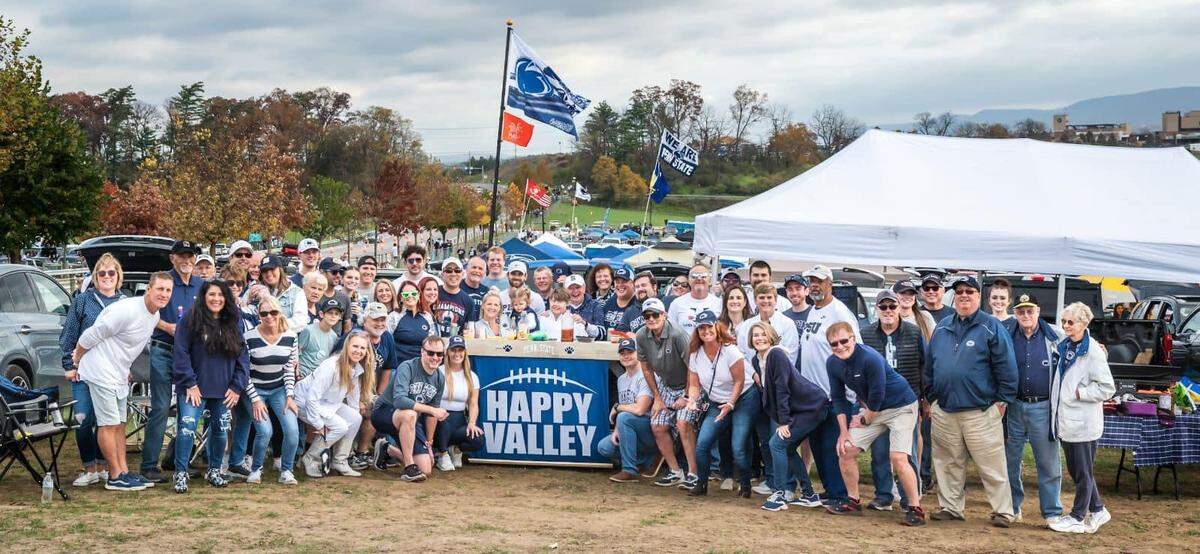 Members of the Cherry Tailgate Group pose for a photo in Lot 32 near Beaver Stadium.