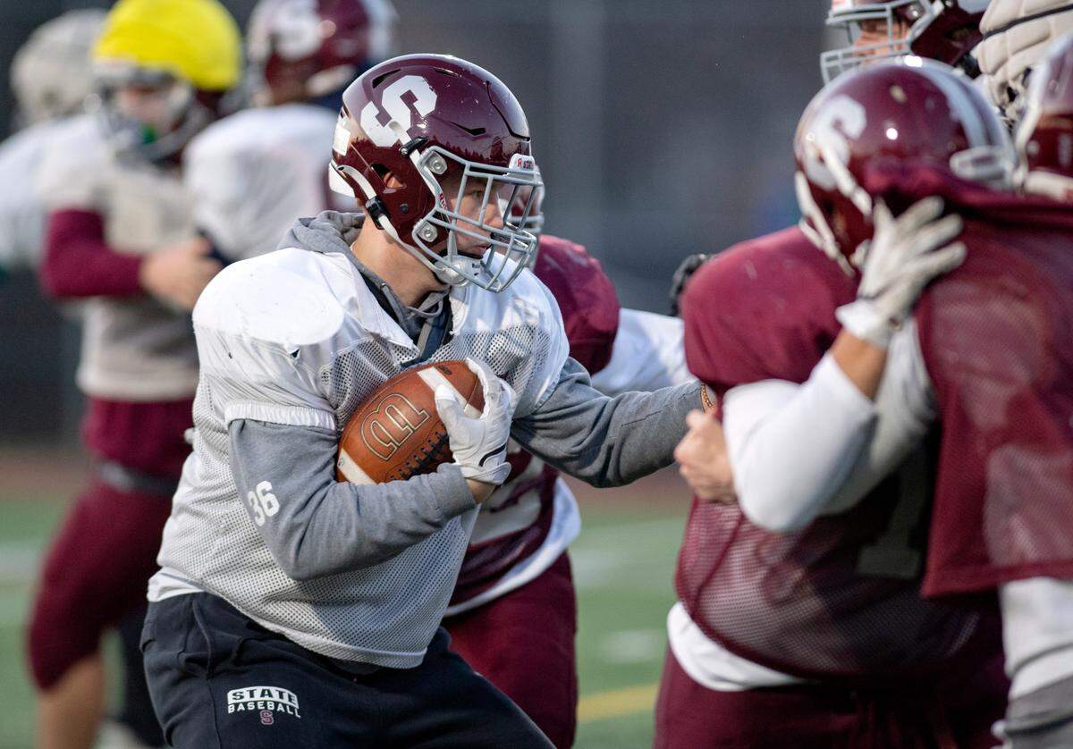 State College’s Brady Bendik runs a play during football practice on Tuesday. The Little Lions will face Mount Lebanon in the PIAA class 6A semifinals on Saturday.