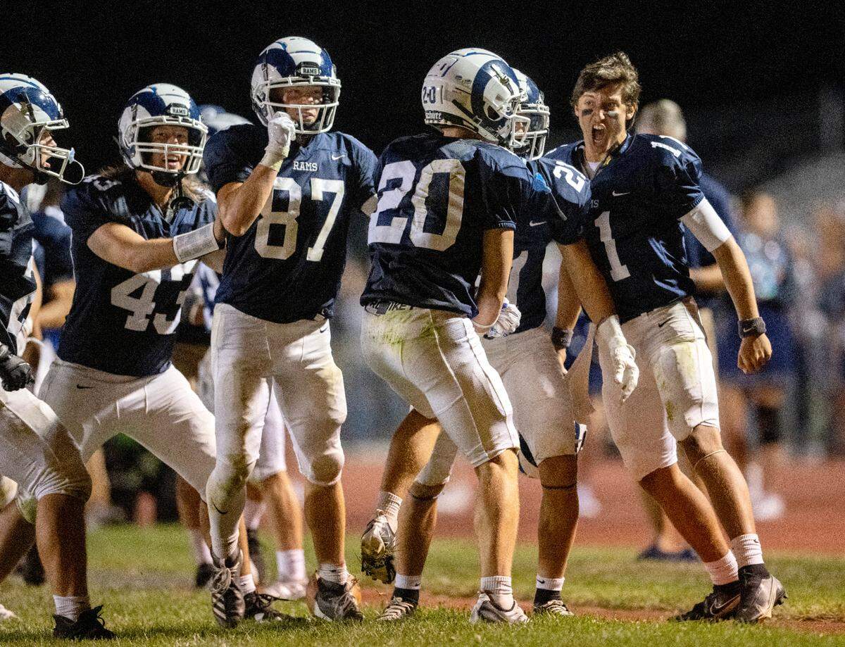 Penns Valley’s John Meyer (20) celebrates with his teammates after his interception in the third quarter of the game against Bellefonte on Friday, Sept. 2, 2022.
