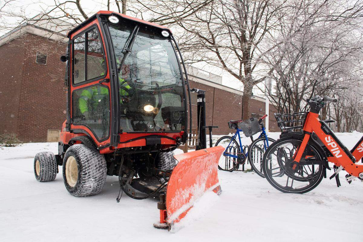 A worker for the Borough of State College plows sidewalks Friday after a winter storm.