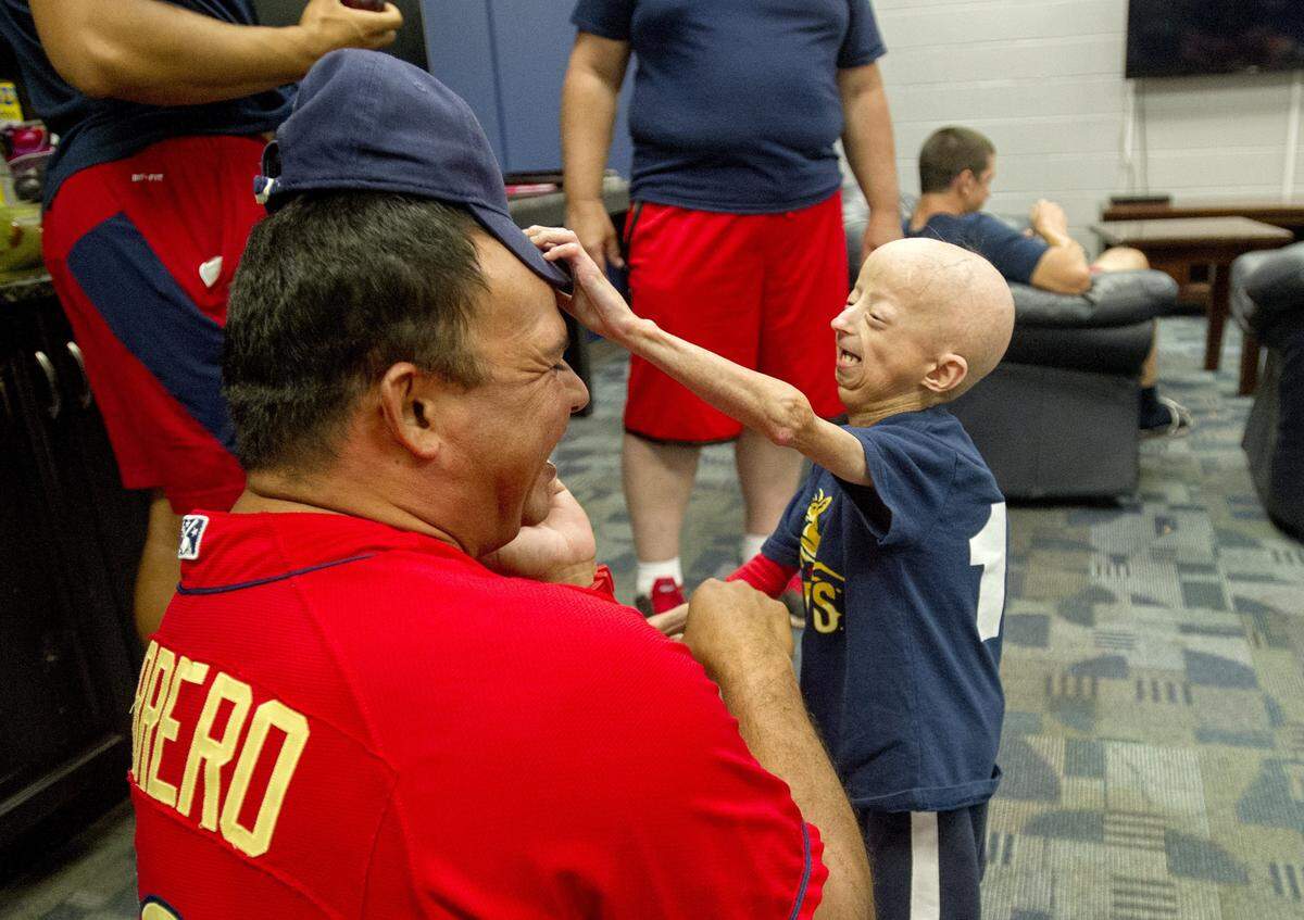 Pitching coach Darwin Marrero laughs as Josiah Viera reaches to get his hat back as they hang out in the clubhouse the afternoon before a Spikes game. "He's an angel," Marrero said after the laughter subsided.  