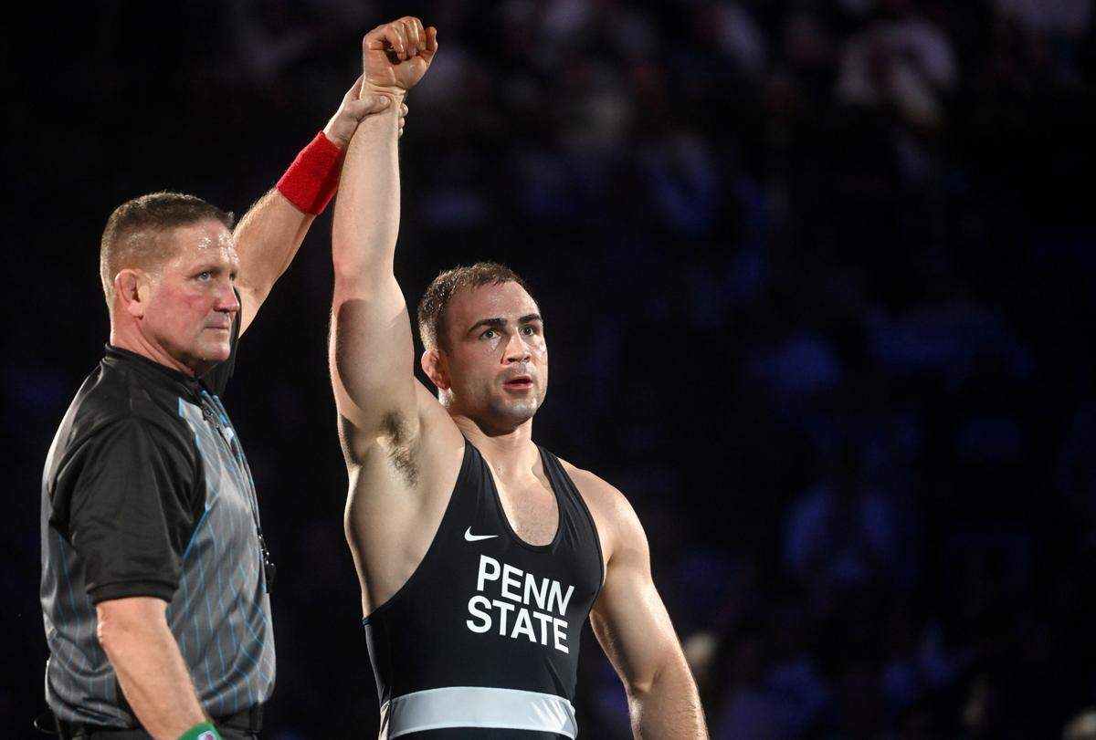 Penn State wrestler Max Dean has his hand raised after winning beating Iowa’s Jacob Warner in the 197 lb bout of the match on Friday, Jan. 27, 2023 at the Bryce Jordan Center.