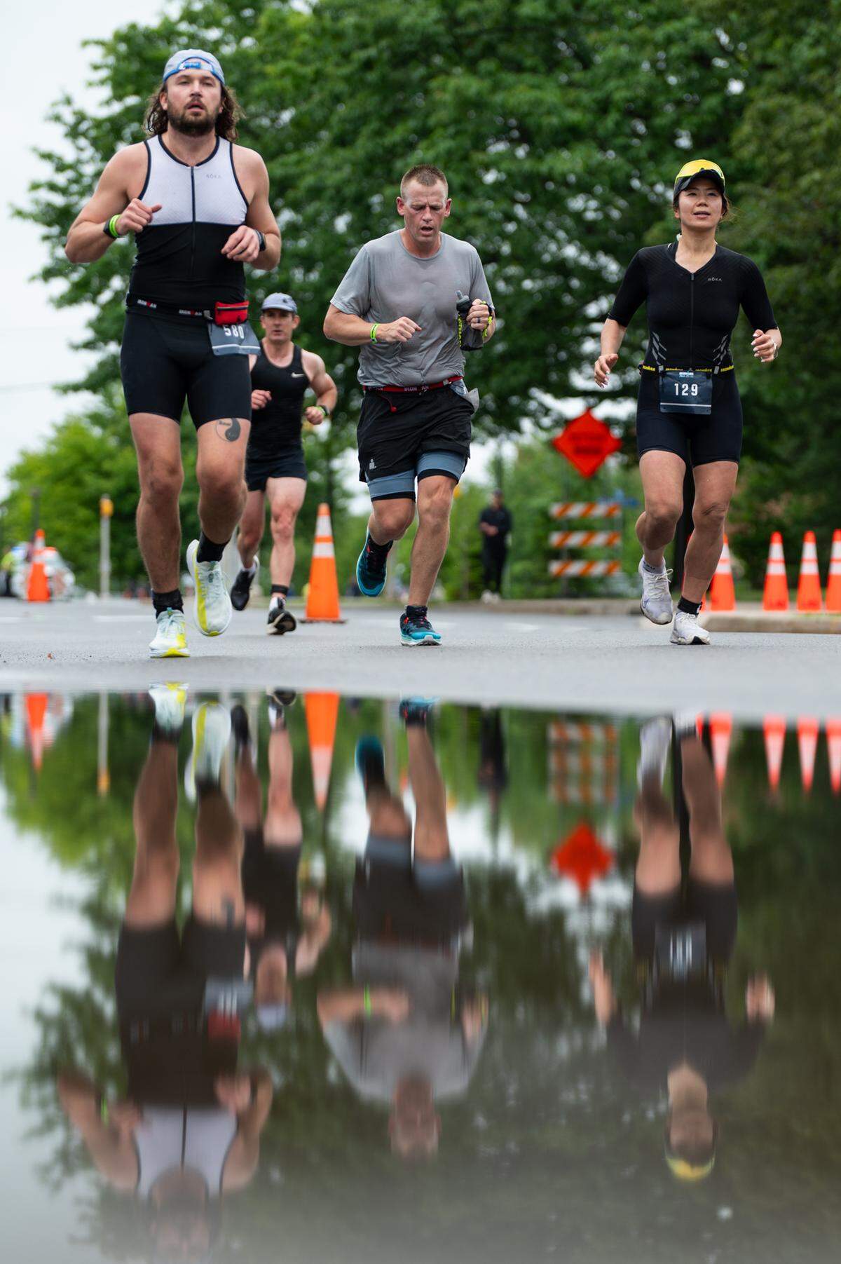 Athletes run down Curtin Road during the third leg of the Ironman 70.3 Happy Valley on Sunday, June 15, 2025 in University Park, Pa.
