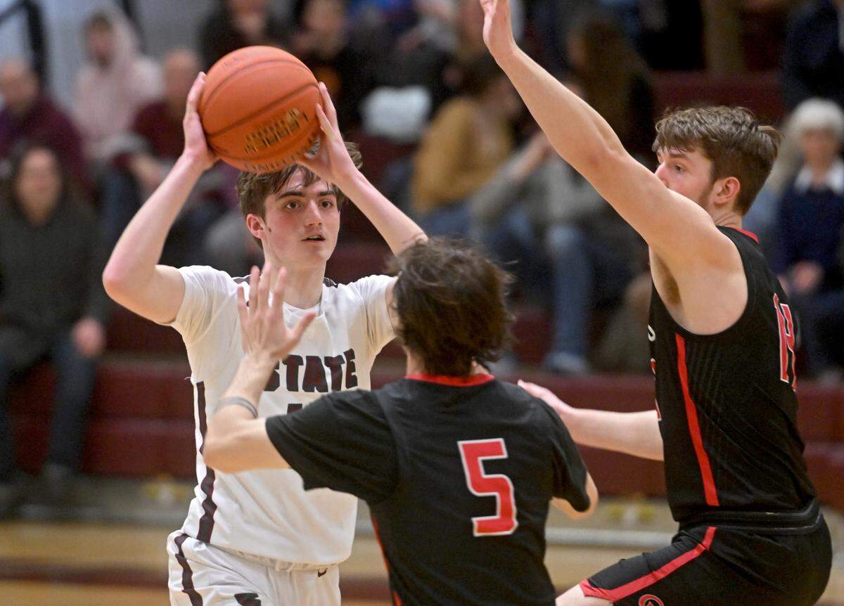 State College’s Ryan Perks looks to make a pass around Cumberland Valley defenders during the game on Tuesday, Feb. 7, 2023.