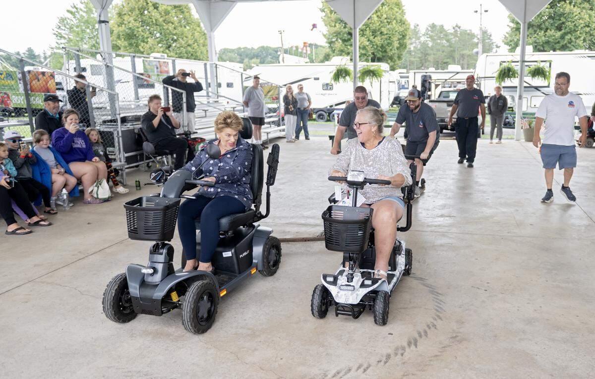 Ladies laugh as they compete in the scooter pull sponsored by T&B Medical at the Centre County Grange Fair on Thursday, Aug. 21, 2025. 