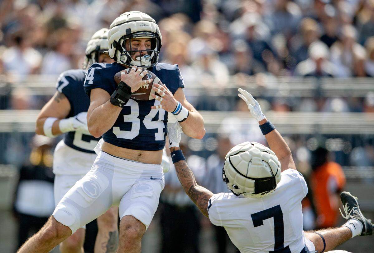 Penn State linebacker Dominic DeLuca intercepts the ball intended for wide receiver Kaden Saunders during the Blue-White game on Saturday, April 23, 2022.