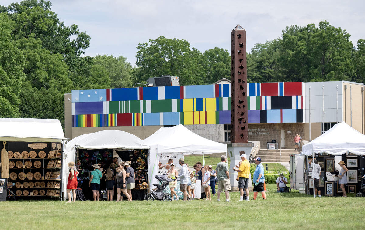 Visitors browse the booths at the People's Choice Festival on the grounds of the Pennsylvania Military Museum in Boalsburg on Thursday, July 9, 2026.