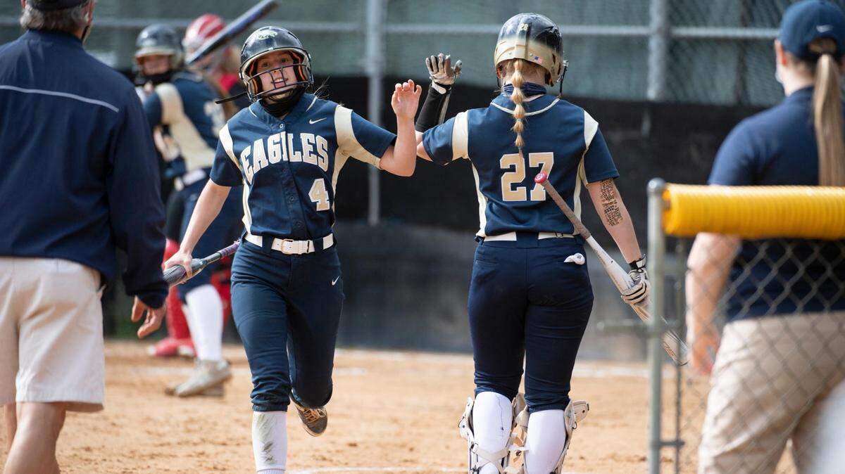 Bald Eagle’s Mara Hockenberry (4) celebrates with Maegan King (27) after scoring during Bald Eagle Area softball’s game against Central High School at the Milesburg youth baseball complex on Tuesday, April 13, 2021 in Milesburg, PA.