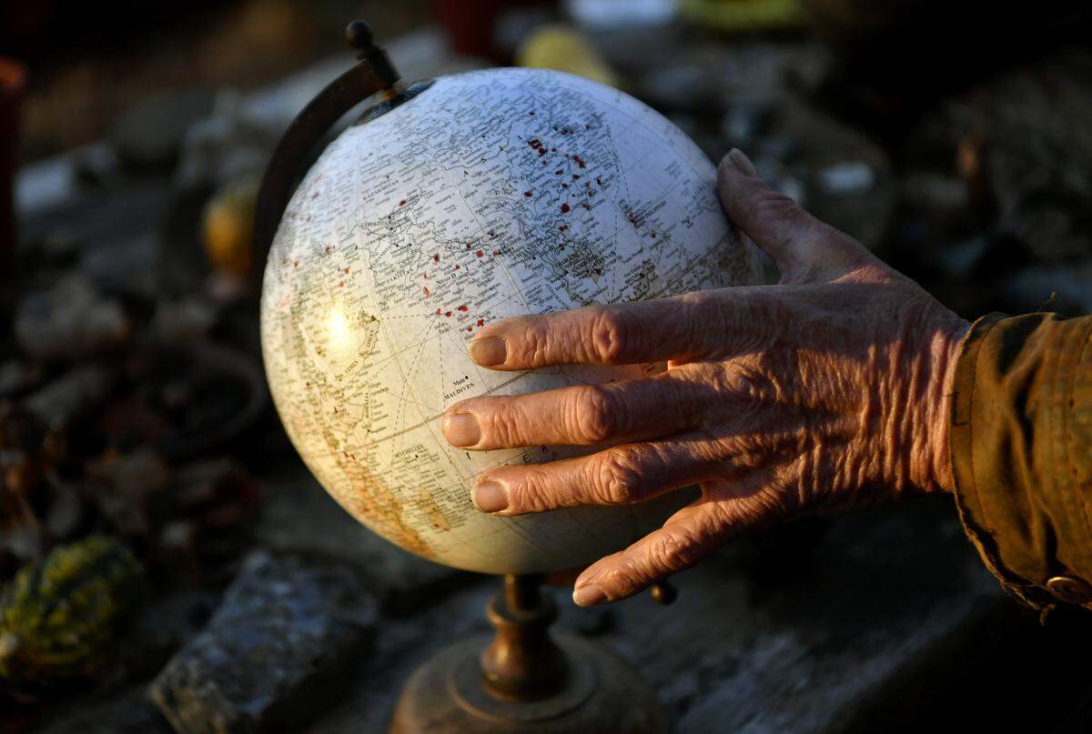 Dan Loerch shows the globe sitting on a picnic table for visitors to mark where they are from after hiking the Mount Nittany Trail. Loerch has moved back to the area after 40 years away from the home he grew up in, The Nittany House.