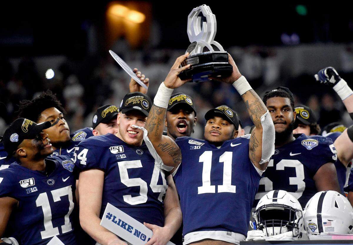 Penn State linebacker Micah Parsons holds up the McKnight Trophy after being names the Cotton Bowl outstanding defensive player after the win over Memphis at AT&T Stadium in Arlington, TX on Saturday, Dec. 28, 2019.