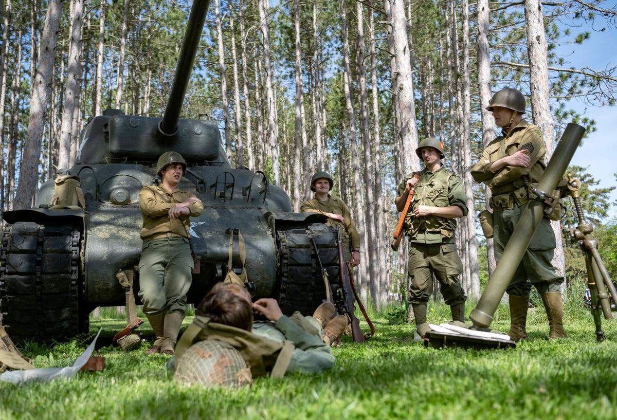 Members of the The Furious Fourth World War II Living History Association wait for visitors at the War II encampment at the Pennsylvania Military Museum on Saturday, May 27, 2023.