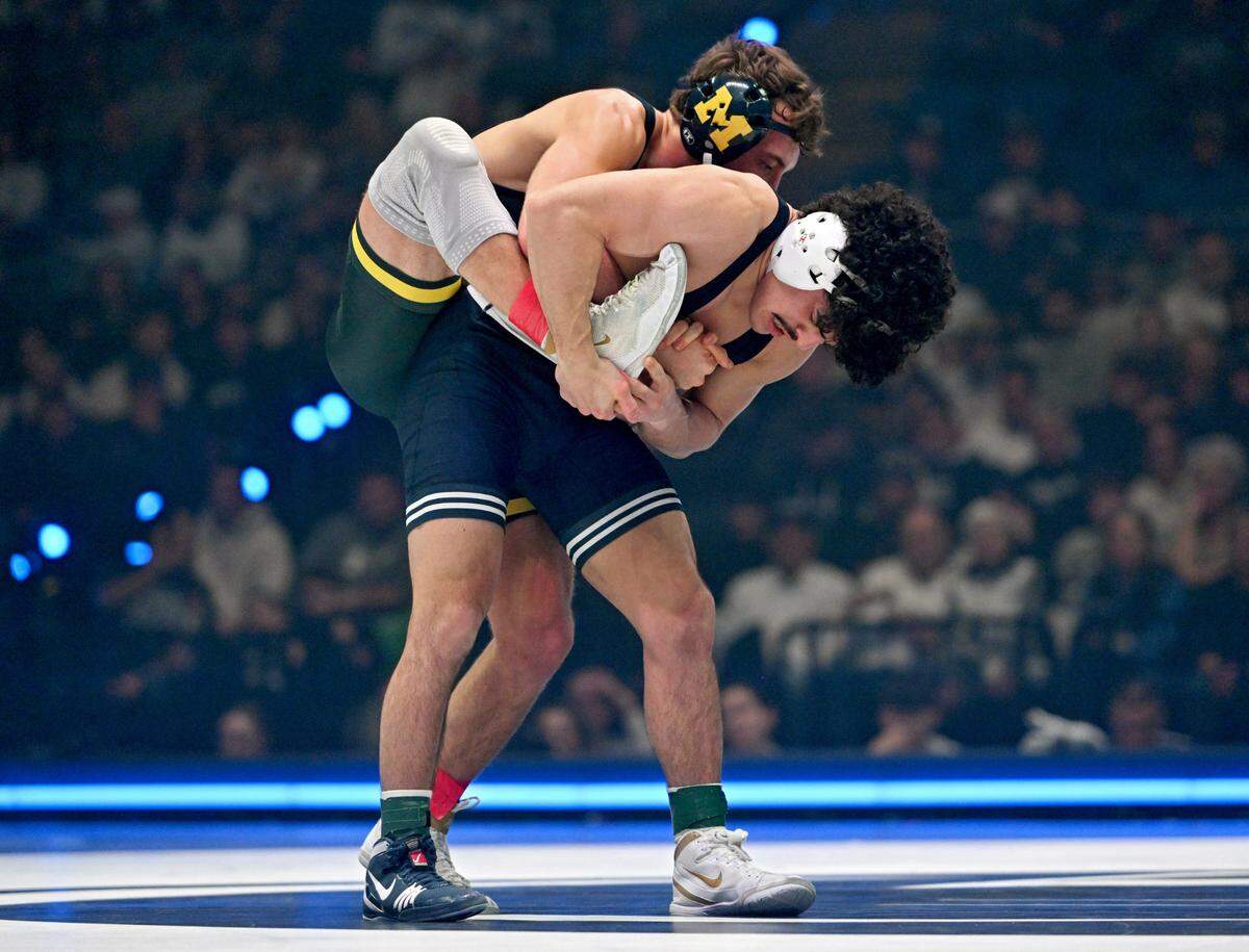 Penn State’s Beau Bartlett holds onto the foot of Michigan’s Sergio Lemley during their 141 lb bout of the match on Friday, Feb. 7, 2025 in the Bryce Jordan Center. Bartlett won by decision, 3-2.