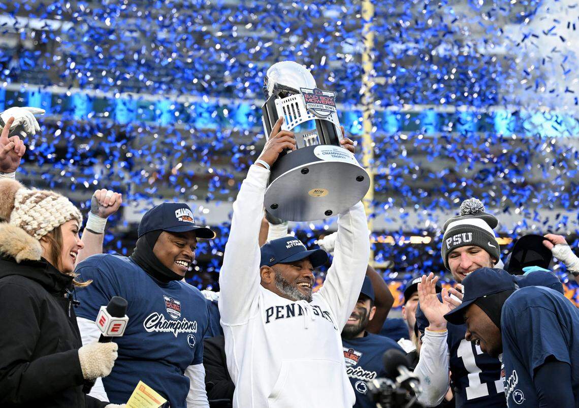 Penn State interim coach Terry Smith holds up the Pinstripe Bowl trophy after the 22-10 win over Clemson at Yankee Stadium on Saturday, Dec. 27, 2025.