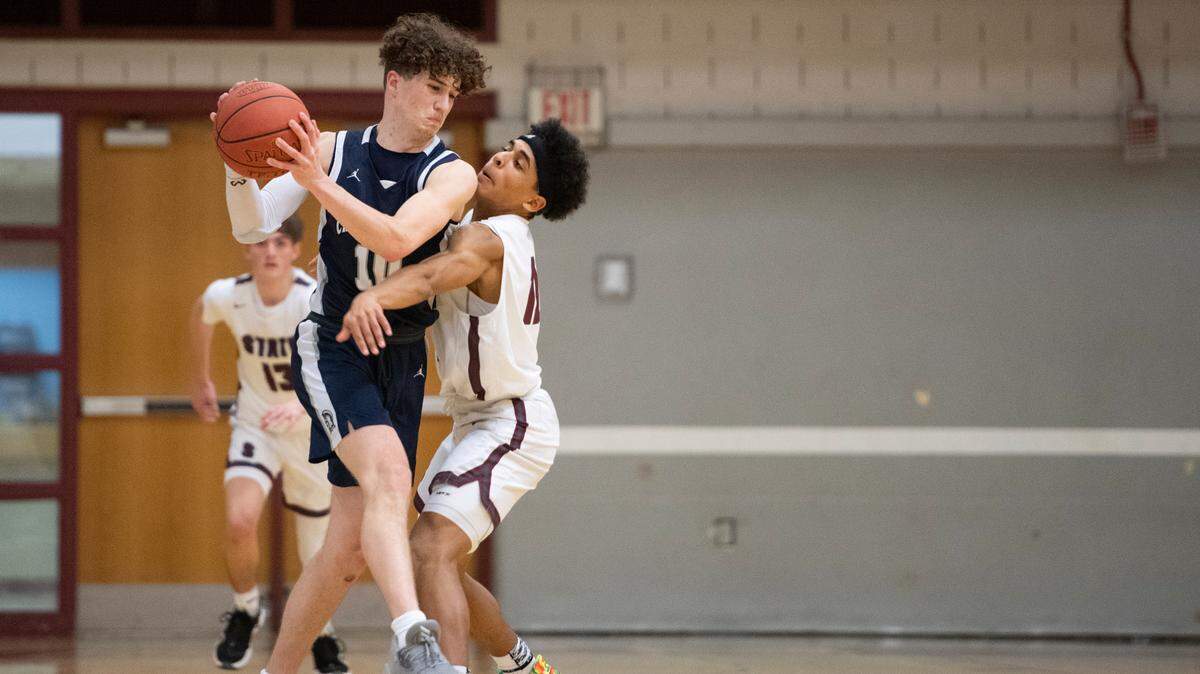 Chambersburg’s Eli Shearer battles State High’s Lake Black during a PIAA basketball game between State High and Chambersburg at the State High gym on Tuesday.