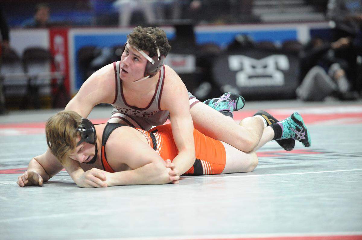 State College wrestling’s Ty Price earned a 5-3 decision over Cathedral Prep’s Hunter Tirpak at 195 pounds Friday in the PIAA Class 3A dual championships at the Giant Center in Hershey. Cathedral Prep won 37-33.