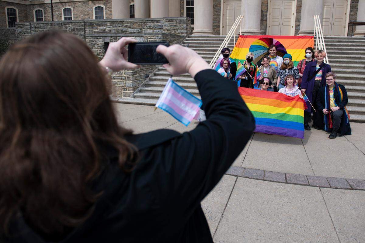 A group takes a photo during a Pride event at Penn State’s Old Main on Monday.