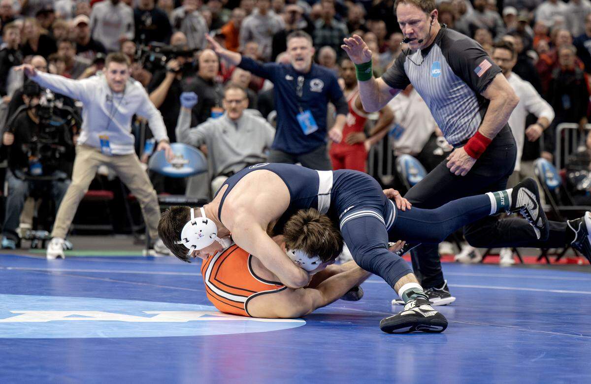 Coaches and fans react as Penn State's PJ Duke controls Oklahoma State’s Landon Robideau in a 157-pound semifinal bout of the NCAA wrestling championships on Friday, March 20, 2026.