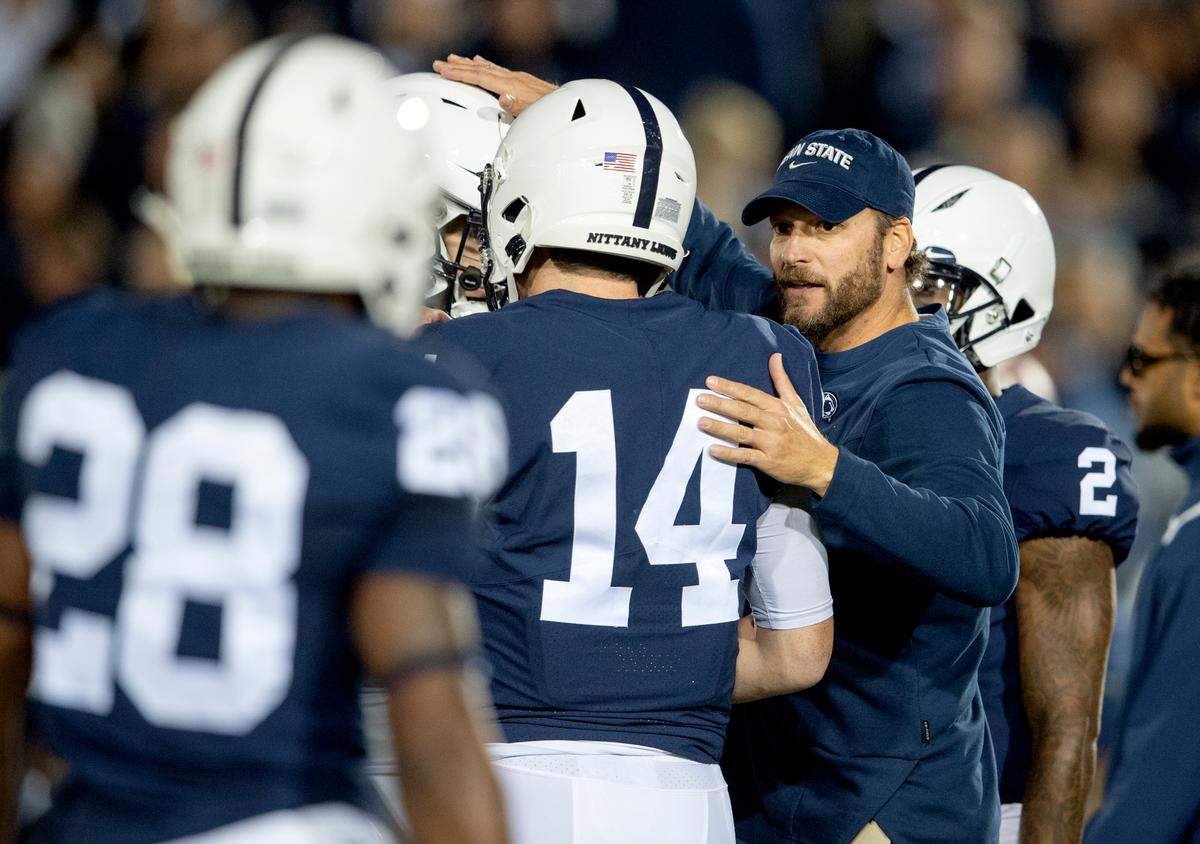 Penn State offensive coordinator Mike Yurcich talks to members of the offense before the game against Indiana.