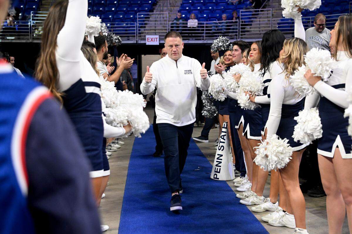 Penn State men’s basketball coach Mike Rhoades walks through the cheerleaders and onto the court for his first game as the coach in the Bryce Jordan Center on Monday, Nov. 6, 2023.
