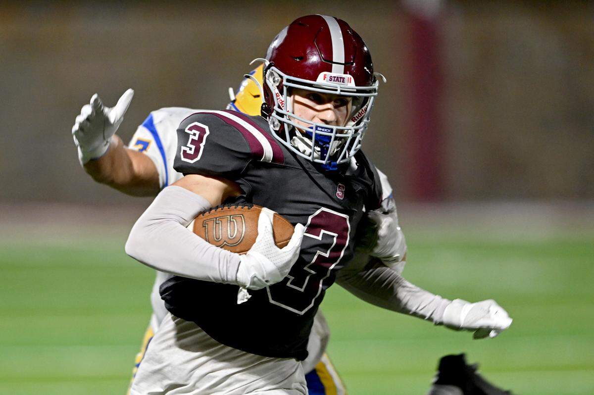 State College’s Ty Salazer outruns a Downingtown East defender during the game on Friday, Sept. 1, 2023.